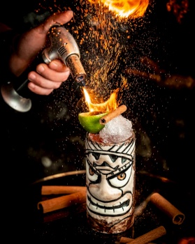 flamed cocktail with ice and fruits