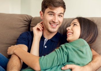 Young couple sitting on the sofa and dating