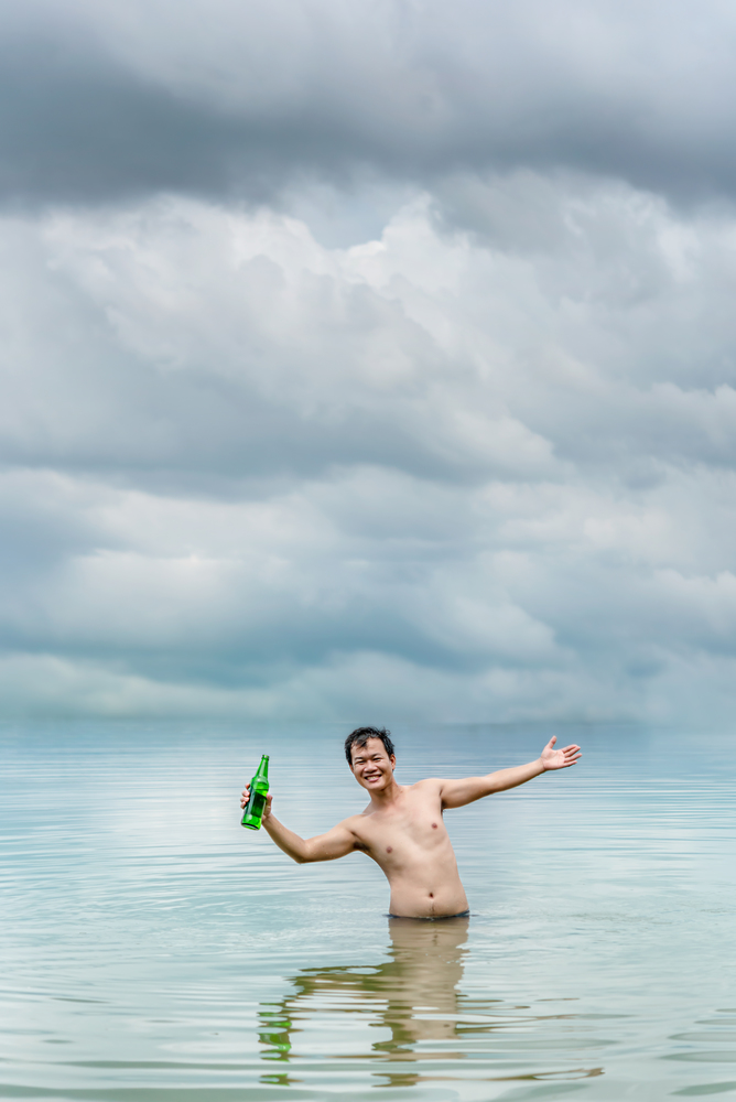 A very happy man  with outstretched arms  in the sea. happy man with outstretched arms