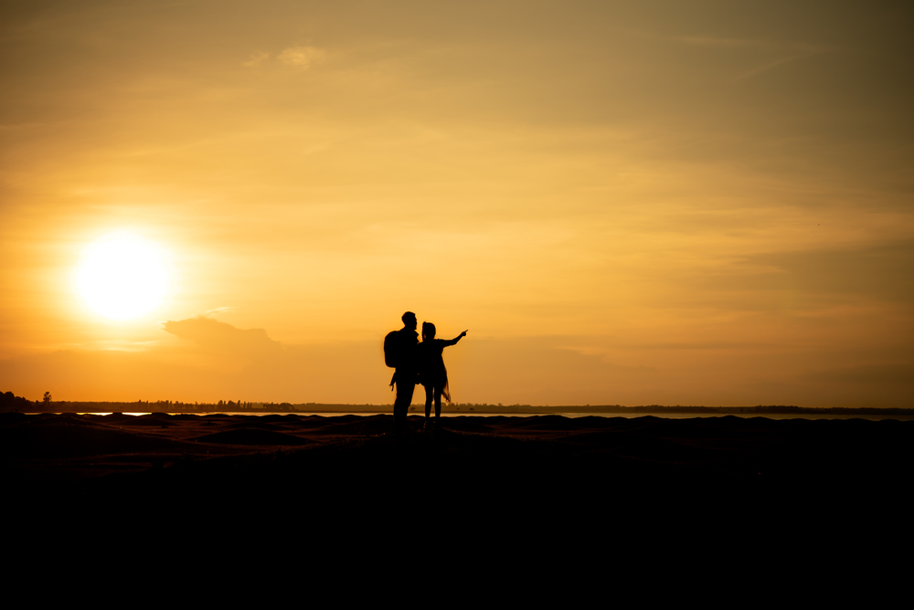 Silhouette traveler couples walking  on mountain at sunset times. Silhouette traveler couples walking