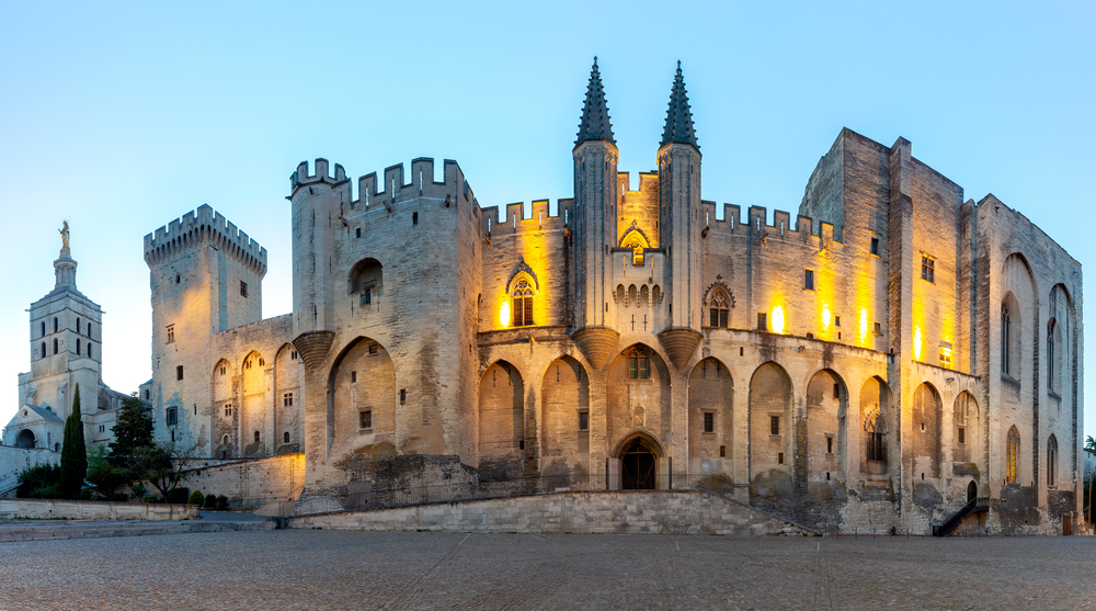 Panorama of the building of the famous medieval papal palace at dawn. Avignon. France.. Avignon. Provence. Panorama of the papal palace at night.