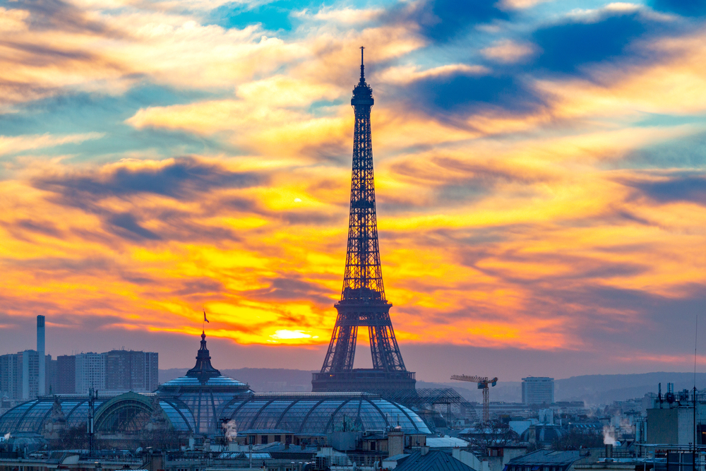 Scenic view of the city and the silhouette of the Eiffel tower on a sunset background. Paris. France.. Paris. Aerial city view at sunset.