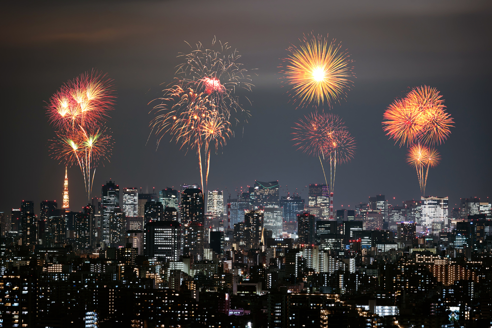 Fireworks celebrating over Tokyo cityscape at night, Japan