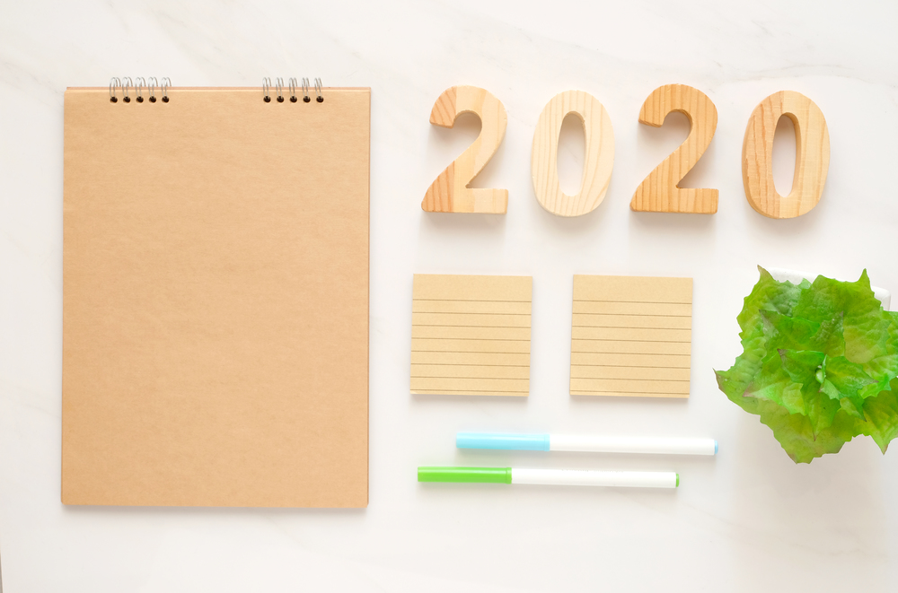 2020 wooden letters and blank notebook paper background with copy space for text, new year background banner concept