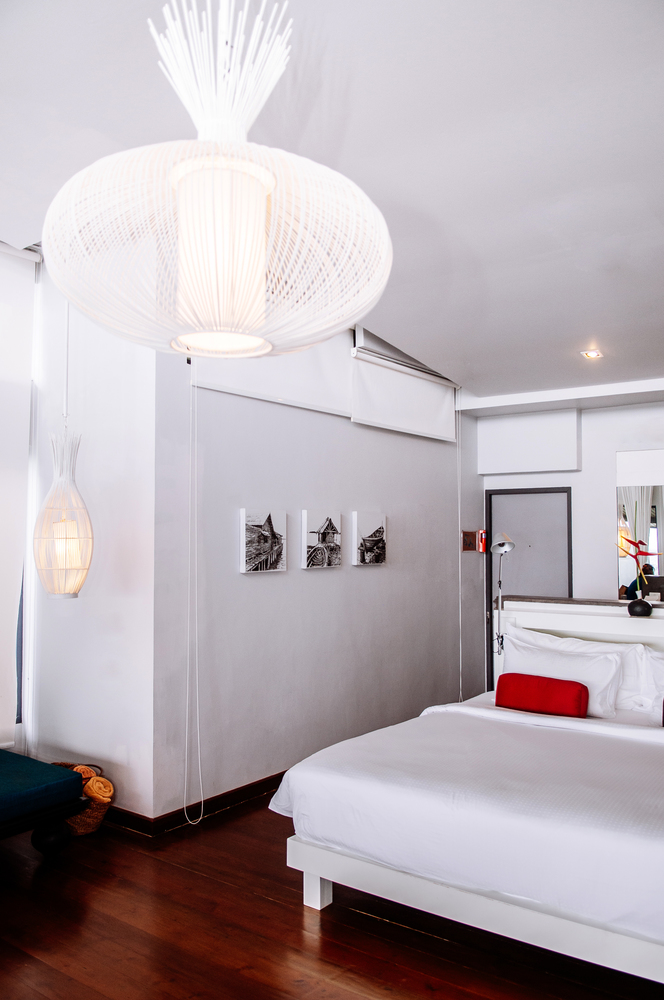 MAY 22,2014 Koh Lanta, Krabi, Thailand - White modern minimal bedroom interior with picture frame, large pedant lamp and furniture. Modern simple and clean interior design