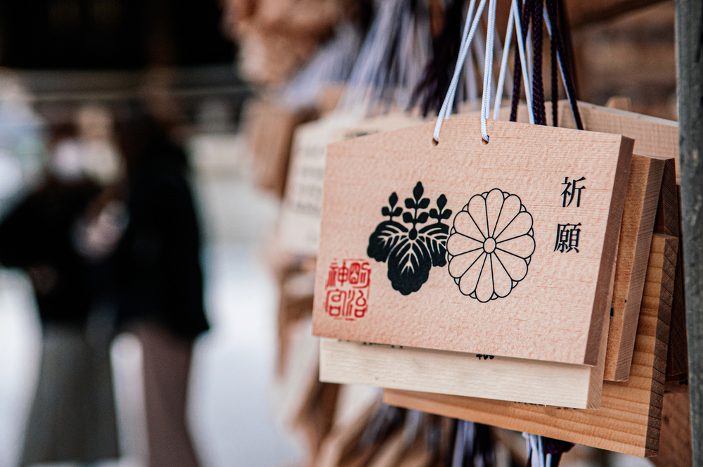 DEC 5, 2018 Tokyo, Japan - Ema wooden Wishing Plaques of Meiji Jingu Shrine with Emperor and goverment symbol hanging after people wrote wishing message