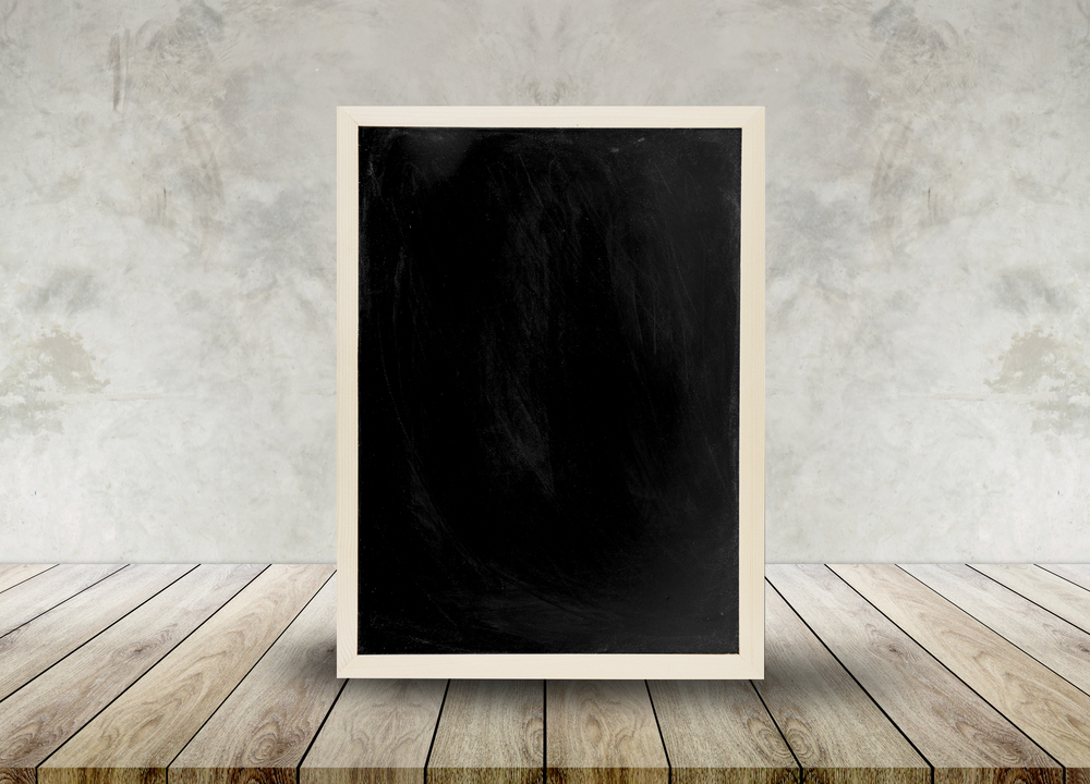 Wooden chalkboard empty table top with cement background, can be used for display your products.