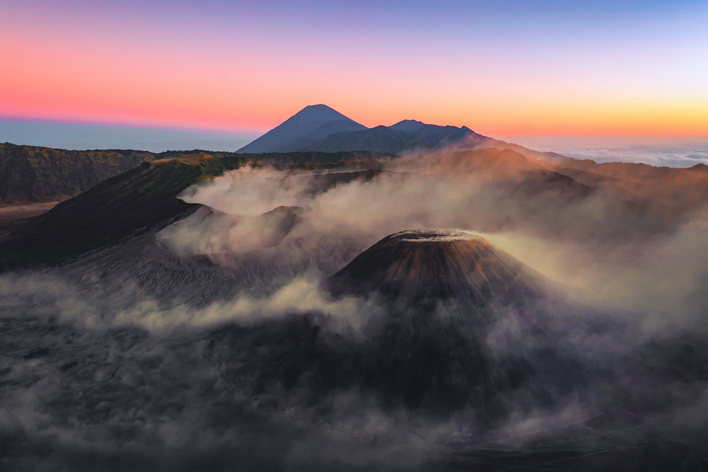 Aerial view of Mount Bromo at sunrise. An active volcano, one of the most visited tourist attractions in east Java from viewpoint, Indonesia. Natural landscape background.