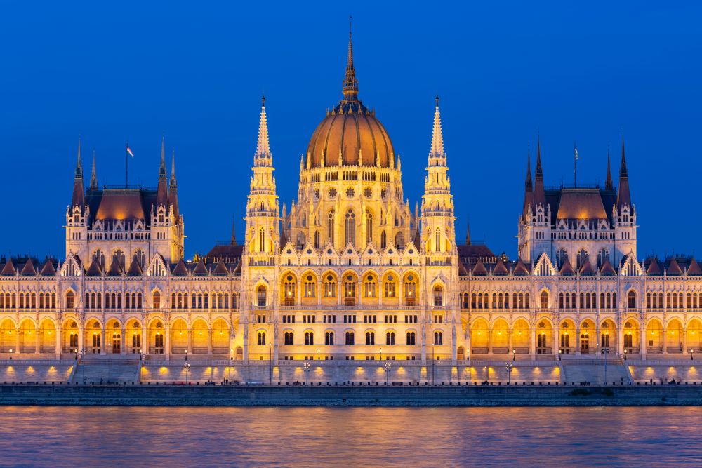 Hungarian Parliament Building along river Danube at night, seat of National Assembly of Hungary. Parliament Building along river Danube at night