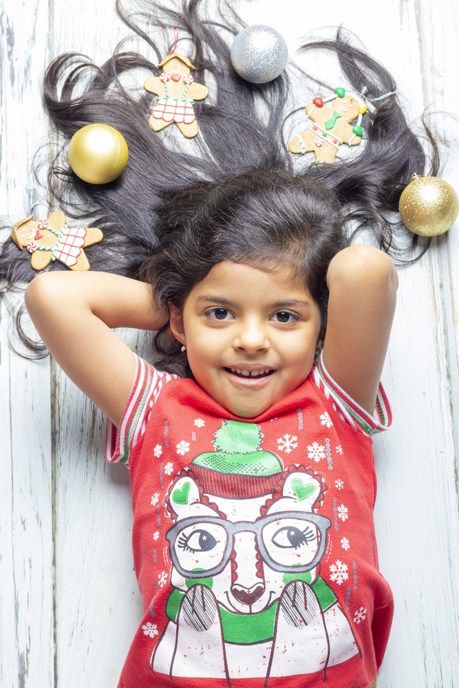 Cute cheerful smiling girl with decorated Christmas hair
