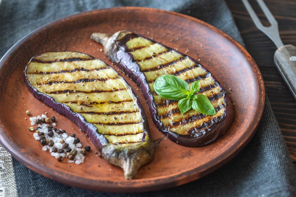 Grilled slices of aubergine with seasonings on the plate
