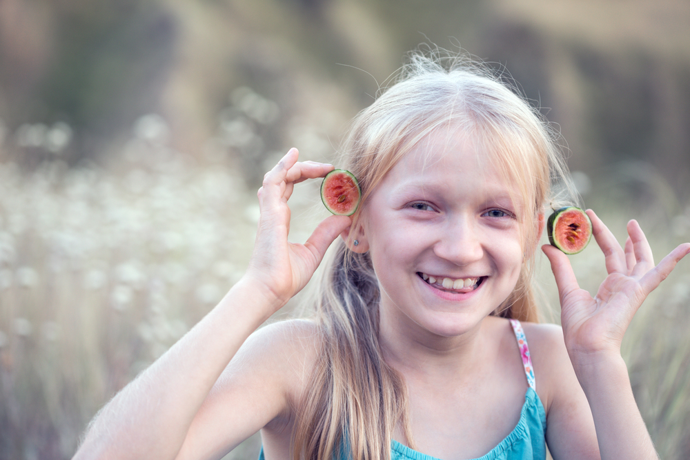 fun happy summer - beautiful blond little girl and watermelon