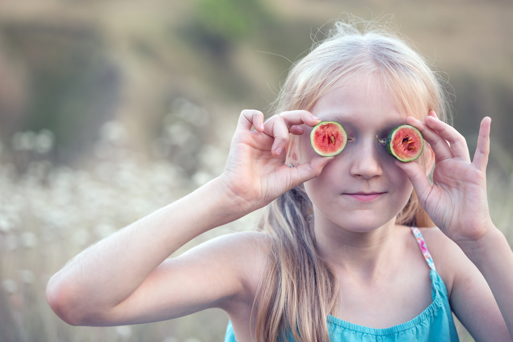 fun happy summer - beautiful blond little girl and watermelon