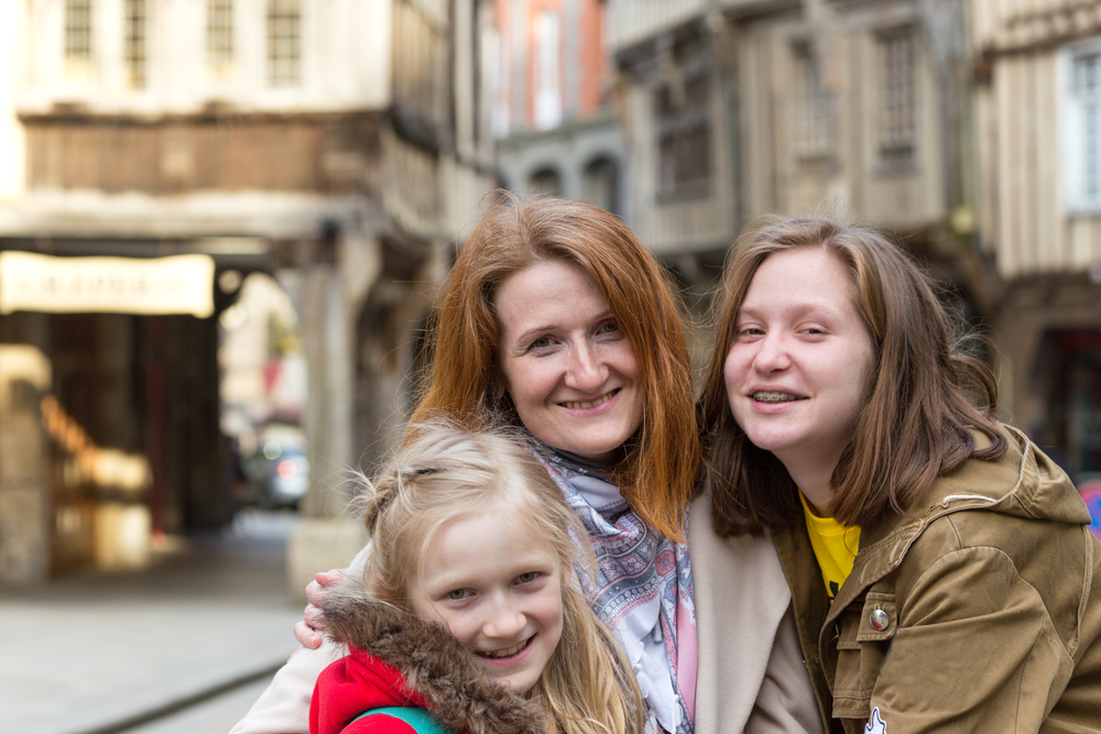 happy mother and daughters  in the famous city of Dinan. Normandy, France