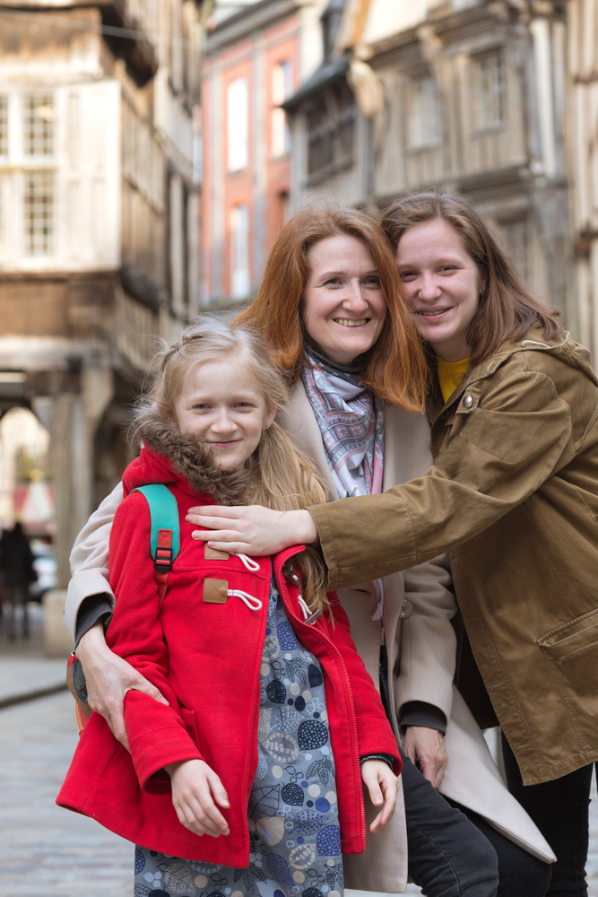 happy mother and daughters  in the famous city of Dinan. Normandy, France