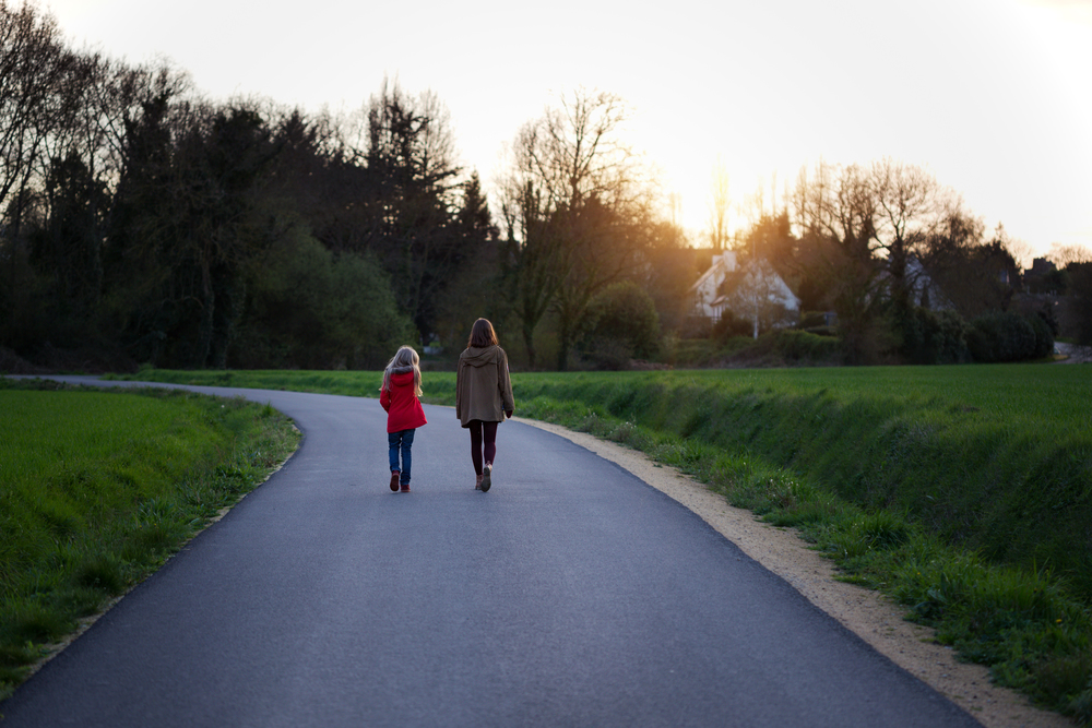 the sisters go along the empty road in the evening. village life
