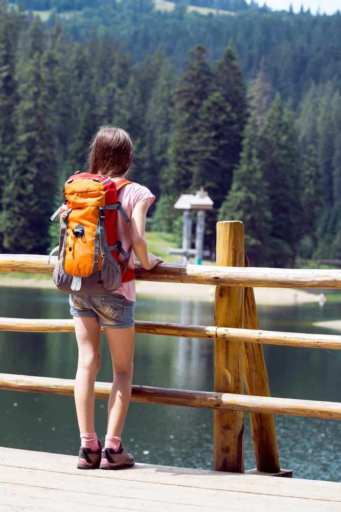 tourist girl and mountain views at the  lake Synevyr. Carpathians,  Ukraine. beautiful landscape