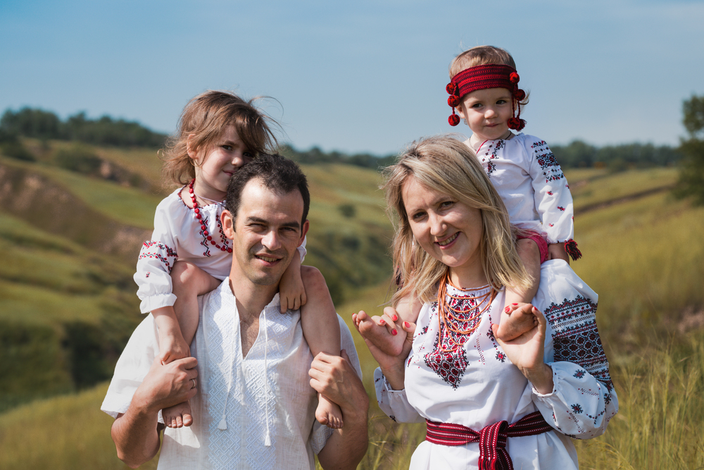 Ukrainian family at the  outdoor. dad, mom and two daughters in traditional national clothes vyshivanka