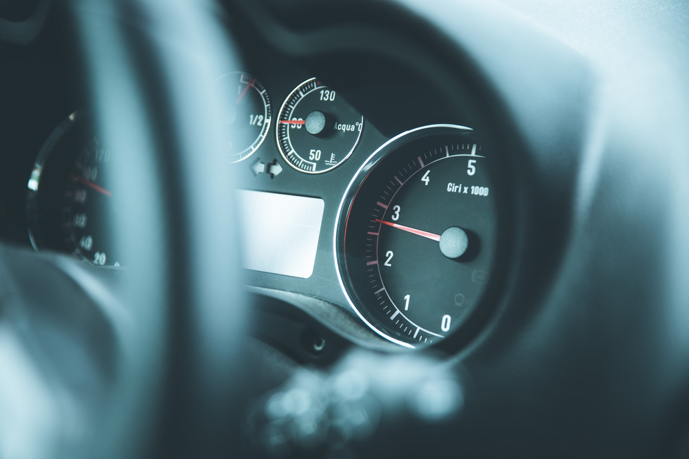 Dashboard of a sports car, steering wheel blurry