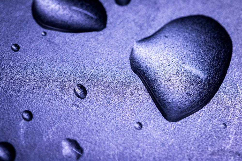 Macro picture of water drops on a metal surface