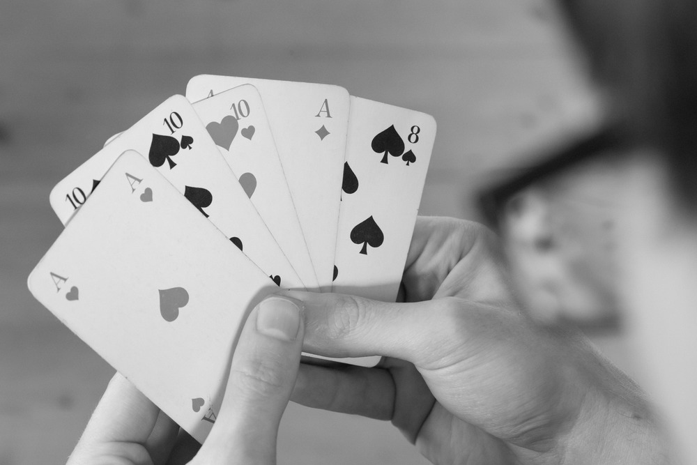 Man is playing cards, cutout of his hands