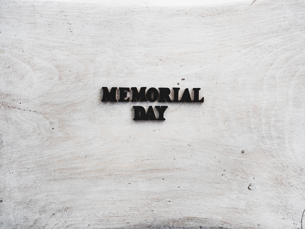 Beautiful card for the Memorial Day. Wooden letters with a congratulatory inscription on a white background. Close-up, top view. Congratulations for loved ones, relatives, friends and colleagues. Beautiful, bright greeting card with a holiday