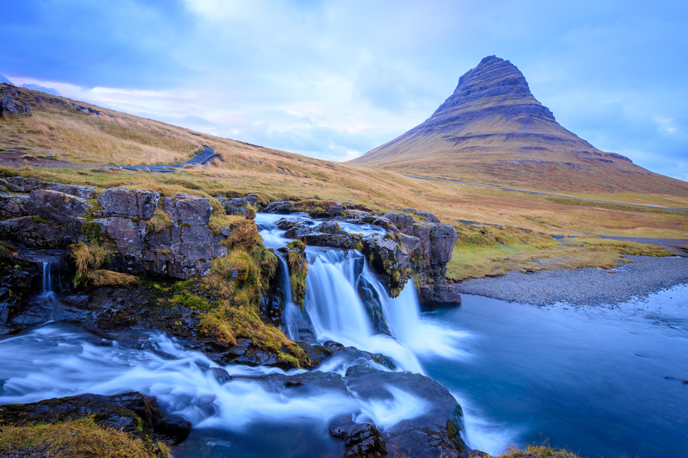Kirkjufell mountain, Iceland. Beautiful sunset over icelandic landscape with mountain and waterfalls