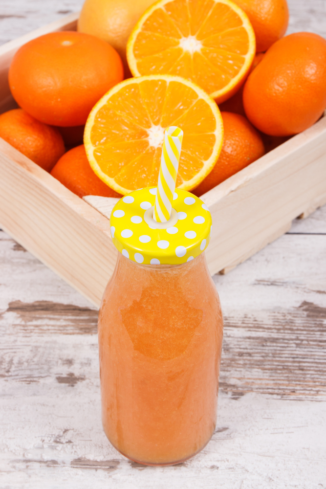 Freshly blended orange coctail from fruits. Concept of diet and healthy nutrition. Freshly blended orange coctail from fruits. Diet and healthy nutrition concept