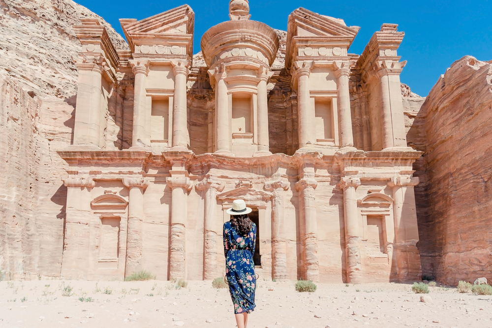 Asian young woman in colorful dress and hat enjoying at The Monastery, Petra&rsquo;s largest monument, UNESCO World Heritage Site, Jordan.
