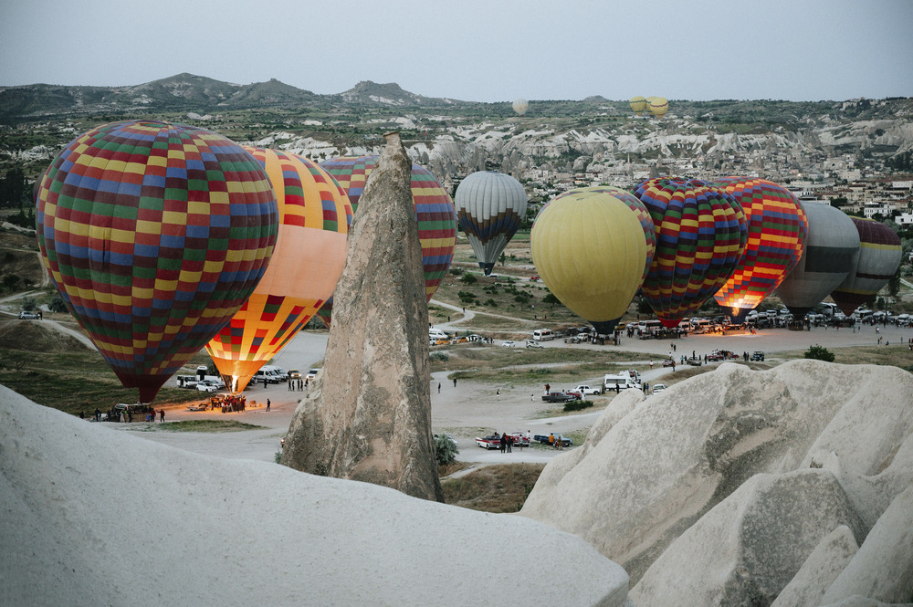 The photo was taken in Turkey, in the name of Cappadocia. The picture shows the flight of balloons over a mountain valley at dawn. Hot air balloons landing in a mountain Cappadocia Goreme National Park Turkey.