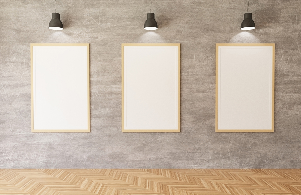 3d rendering White posters and frames hanging on the concrete wall background in the room,lights,wooden floor
