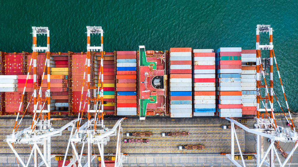 Container ship  loading in a port, Aerial top view container ship in business import export transportation logistic.