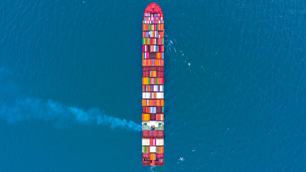 Container ship carrying container for business freight shipping import and export, Aerial view container ship arriving in commercial port.