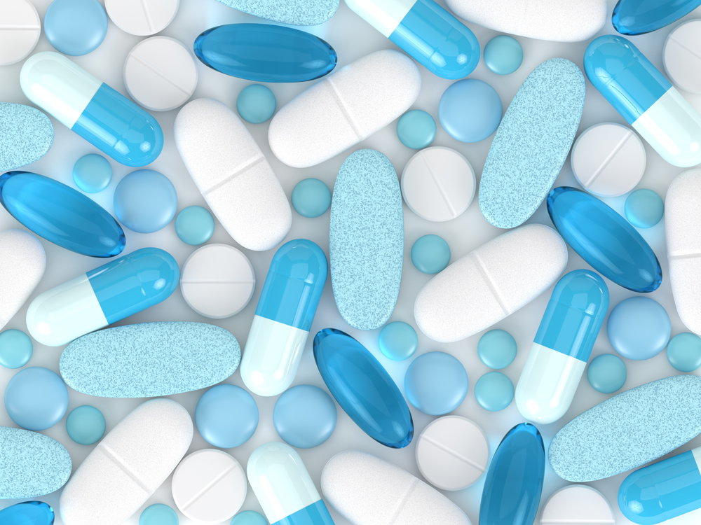 3d render of pills, tablets and capsules over white background
