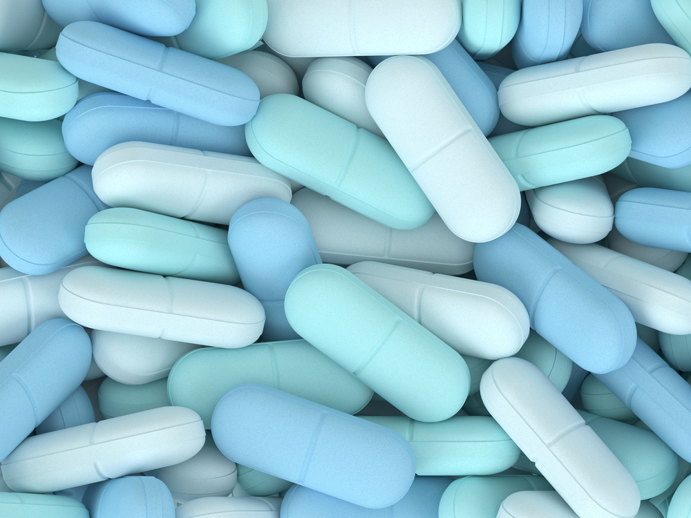 3d render of top view of pills in three colors