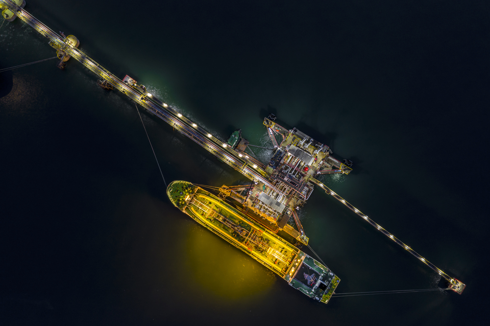 night shot oil tanker transport loading in oil station import and export business  logistics transportation open sea top view