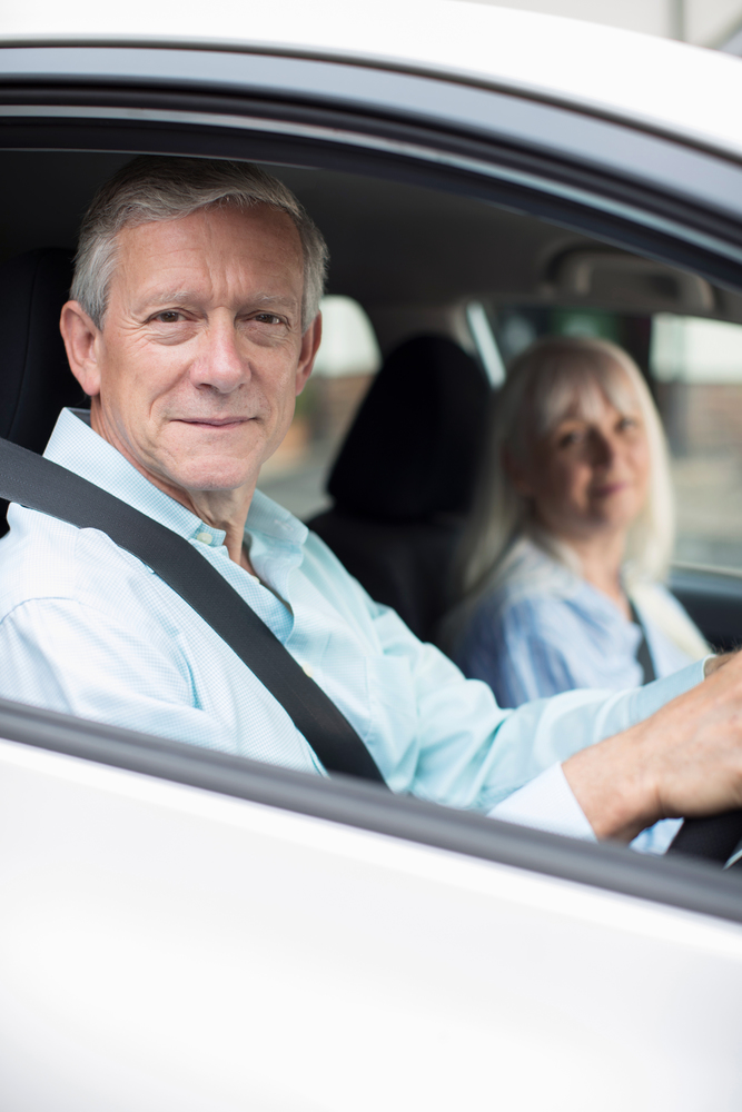Portrait Of Smiling Mature Couple On Car Journey Together