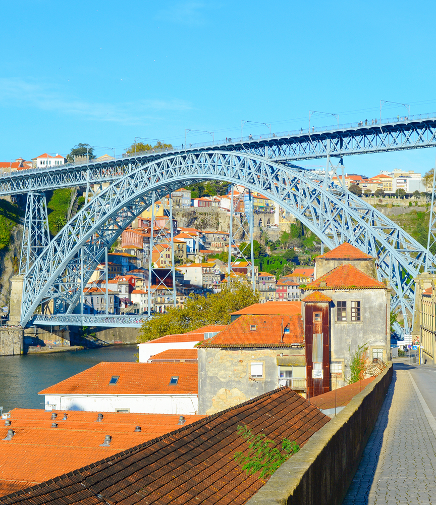 Porto oldtown with famous Dom Luis I Bridge bottom view in bright sunlight, POrtugal
