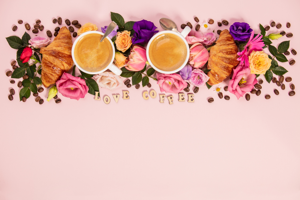 Morning coffee, croissants and a beautiful flowers. Cozy breakfast. Flat lay composition for bloggers, magazines, web designers, social media and artists.