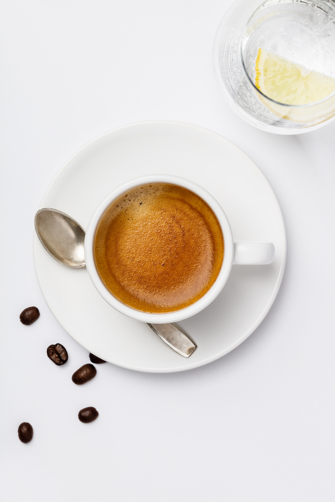 Cup of coffee on white background, flat lay. Cup of coffee on white background, top view