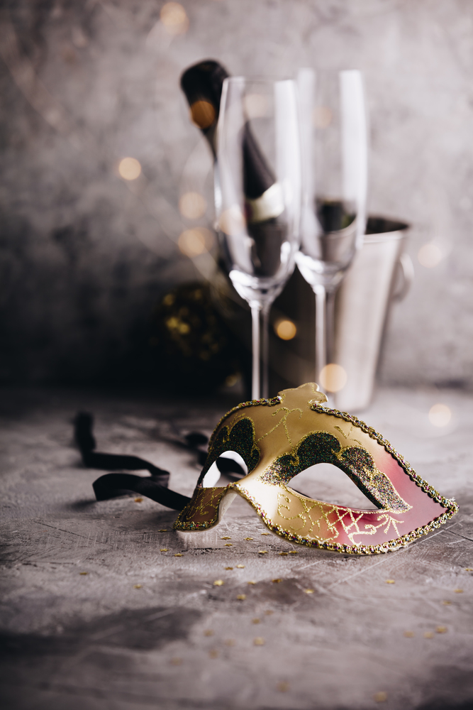 Champagne bottle in bucket with ice, glasses and Christmas decorations on concrete background. Champagne bottle in bucket with ice, glasses and Christmas decorations