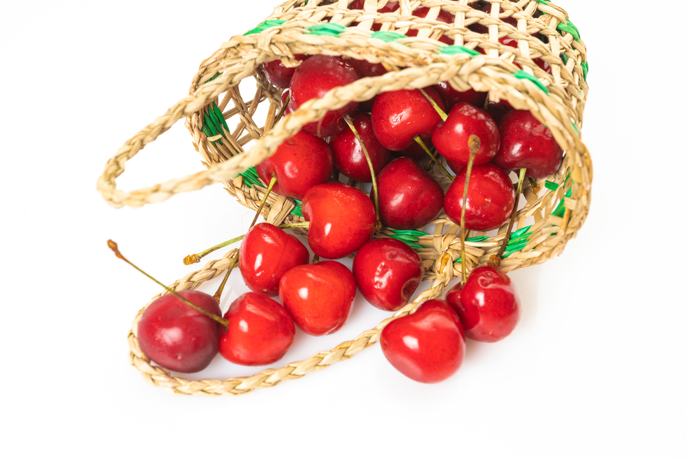 Cherry in basket isolated on a white background