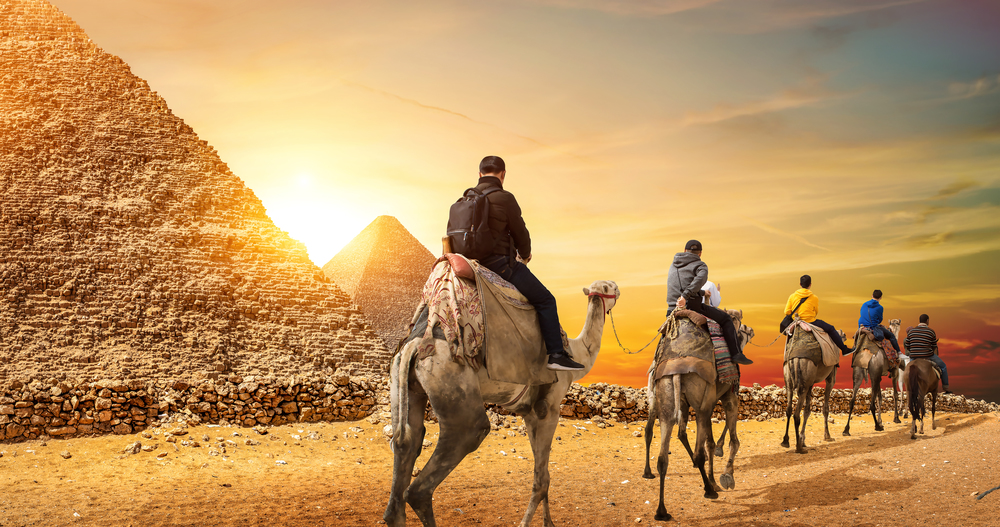 Camel Caravan and the Pyramids of Giza in Egypt