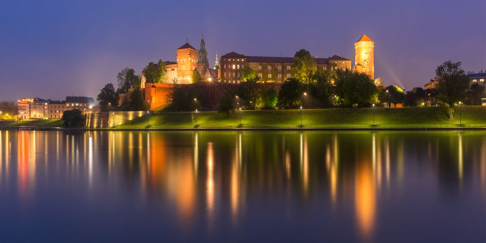 Panorama of Wawel Castle on Wawel Hill with reflection in the river at night as seen from the Vistula, Krakow, Poland. Night Wawel castle, Wroclaw, Poland