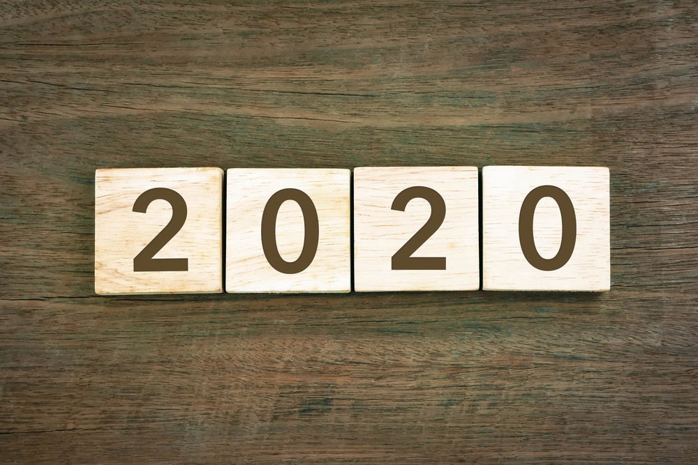 New year Concept 2020 number and typography text on wooden blocks with wood texture background. Top view from above, vintage style for new year resolution and business plan.