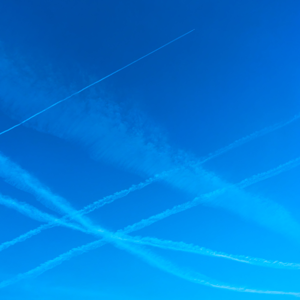 Plane trails in the blue sky - Background