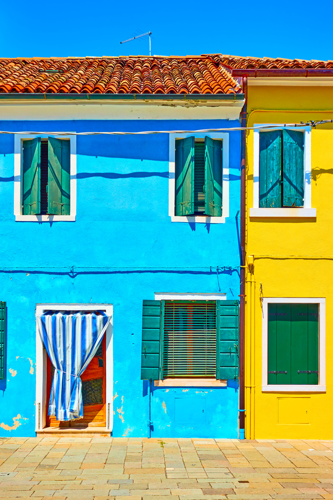 Street with multicolored houses in Burano, Venice, Italy