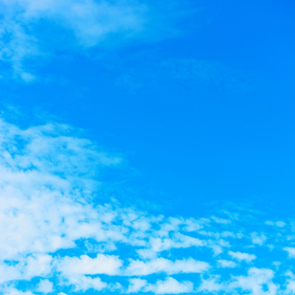 Blue sky with white clouds - Background with space for text