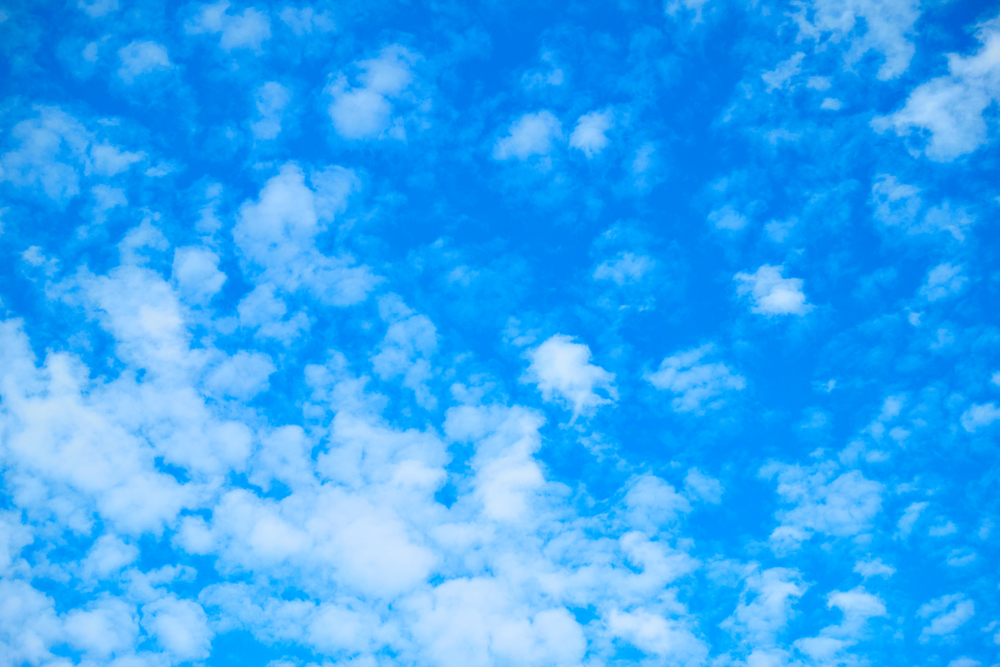 Blue sky with white fleecy clouds, may be used as background
