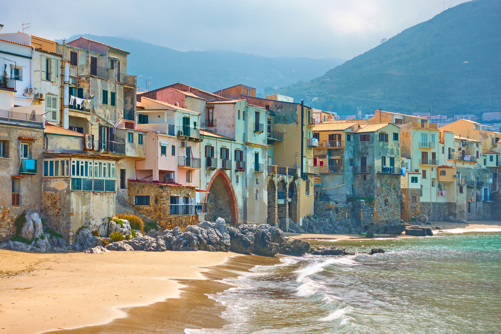 Old colorful houses by the sea in Cefalu town in Sicily, Italy